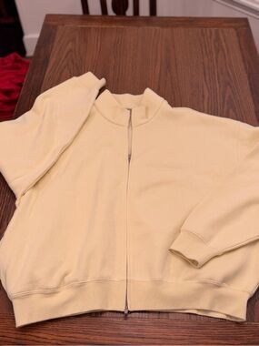 Fear of God Essentials full-zip fleece jacket in a pale yellow
